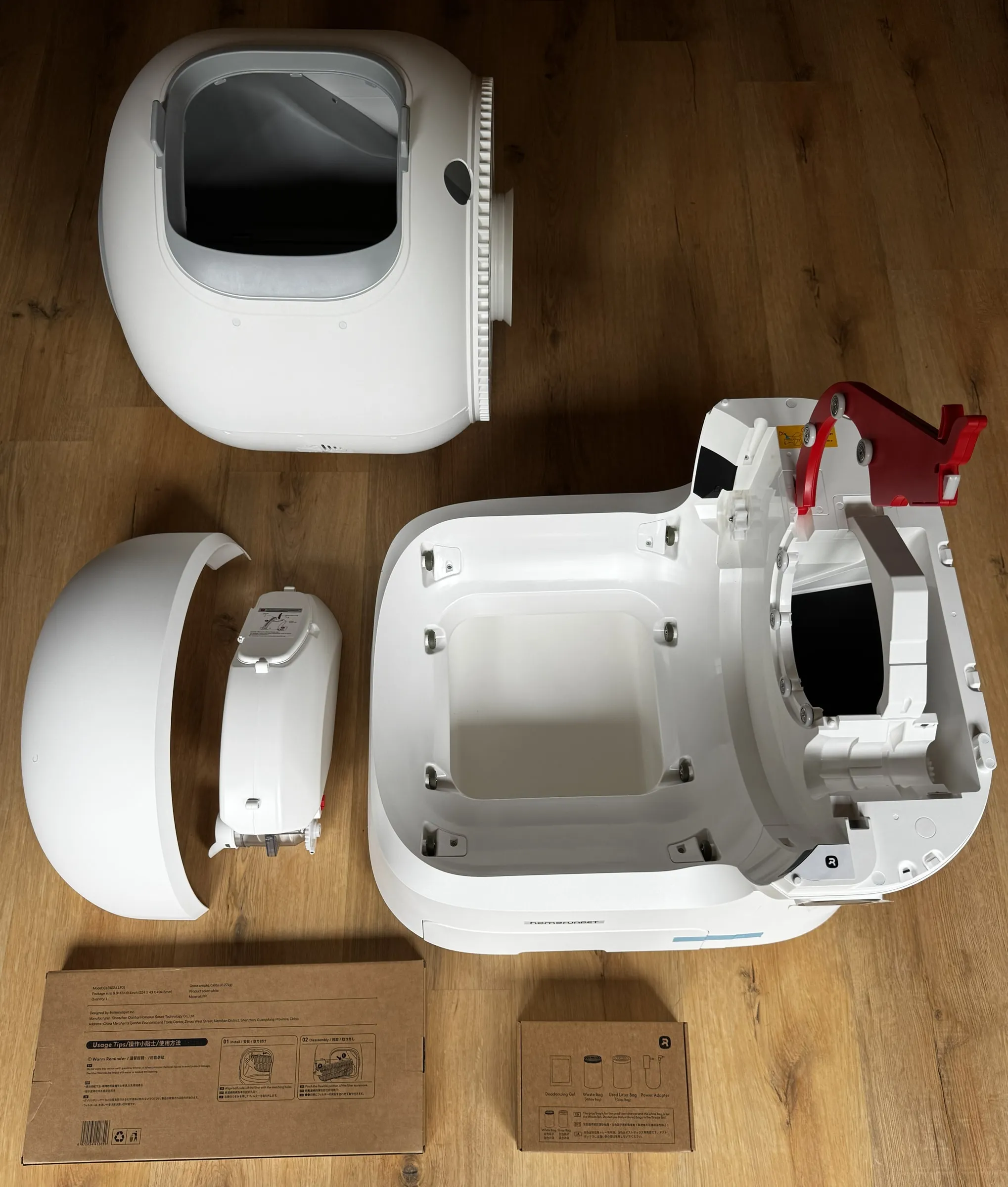 homerunPET CS106 unboxed with the base, dome, auto-refill reservoir, and accessory boxes laid out before setup
